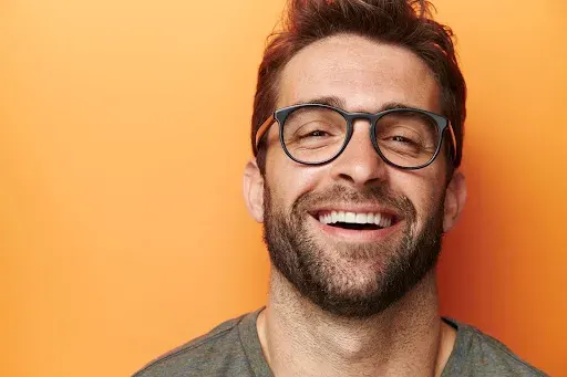 Man with glasses smiling